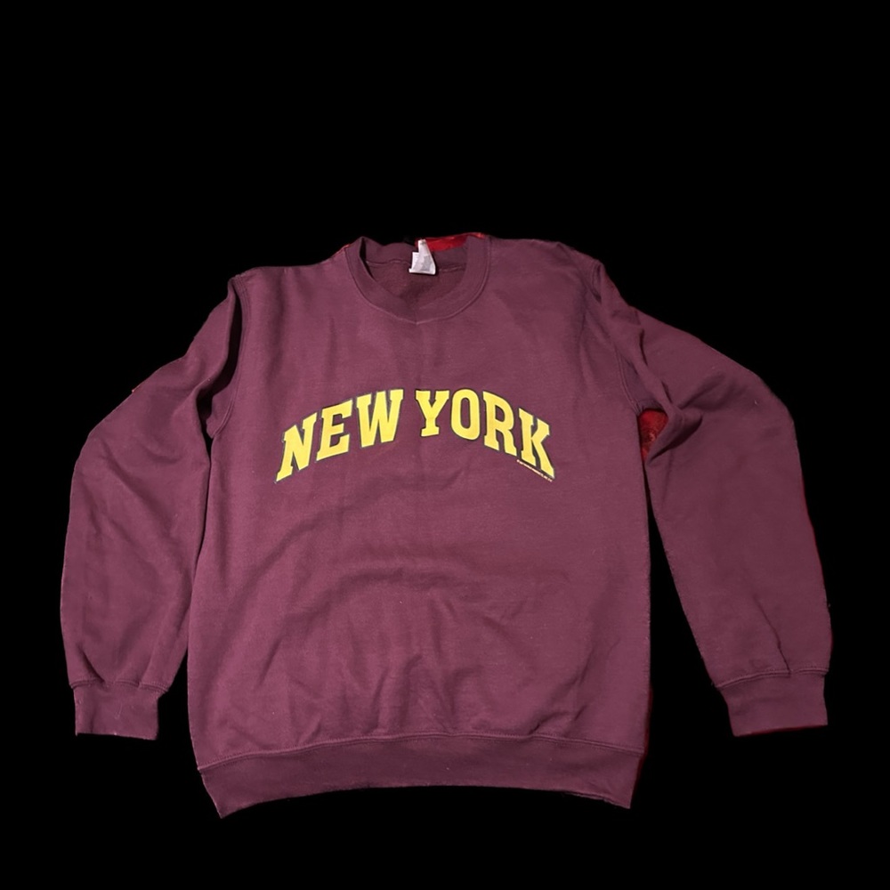 It’s a burgundy sweatshirt from NYC gifts with a yellow NEWYORK logo in it.